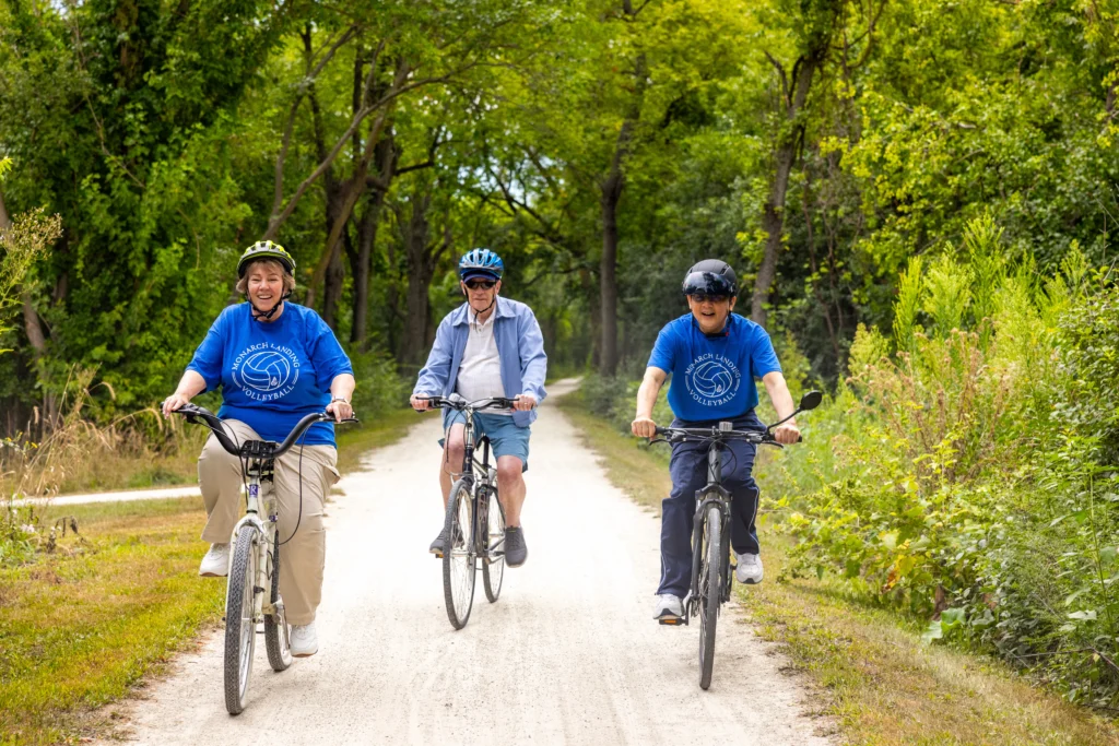 3 residents of Monarch Landing riding bikes, one of the resident lead clubs and social activities for seniors in Naperville, IL.