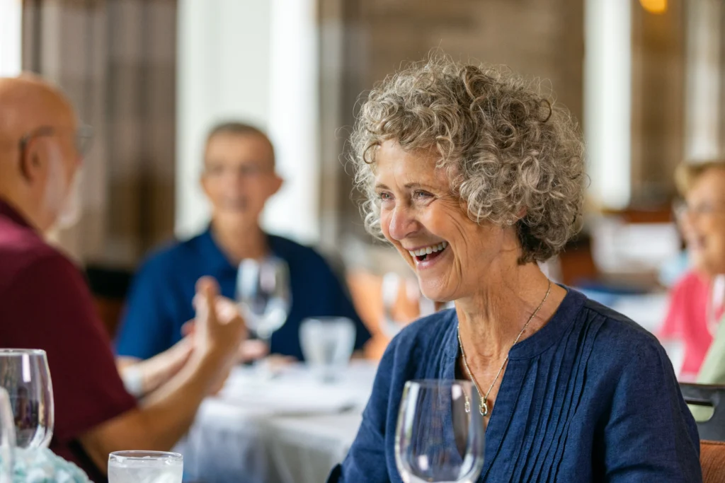 Monarch Landing woman laughs over dinner