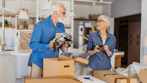 Senior couple moving to a new home couple using their downsizing checklist for seniors to make moving easy