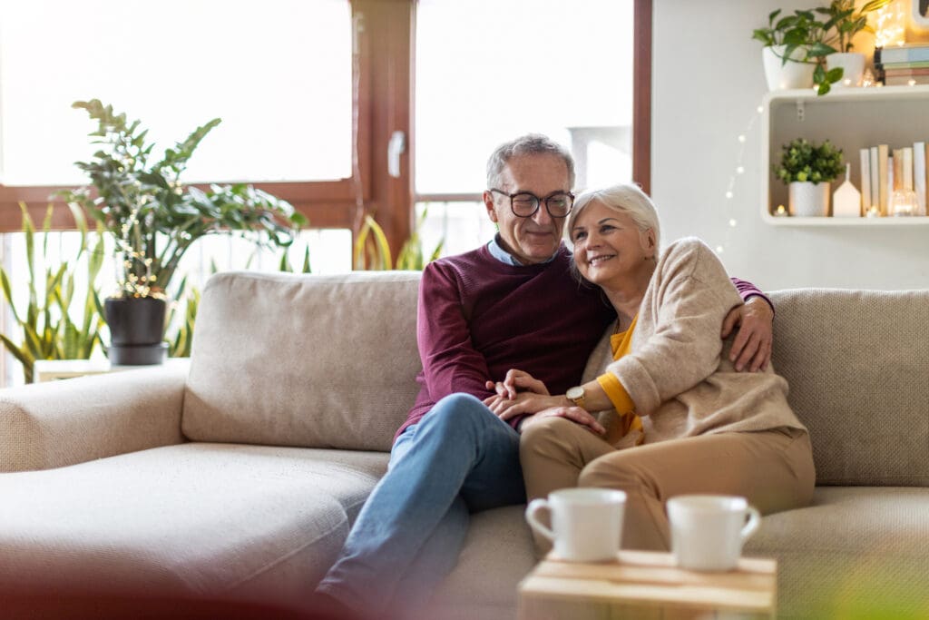 senior couple hugging on couch