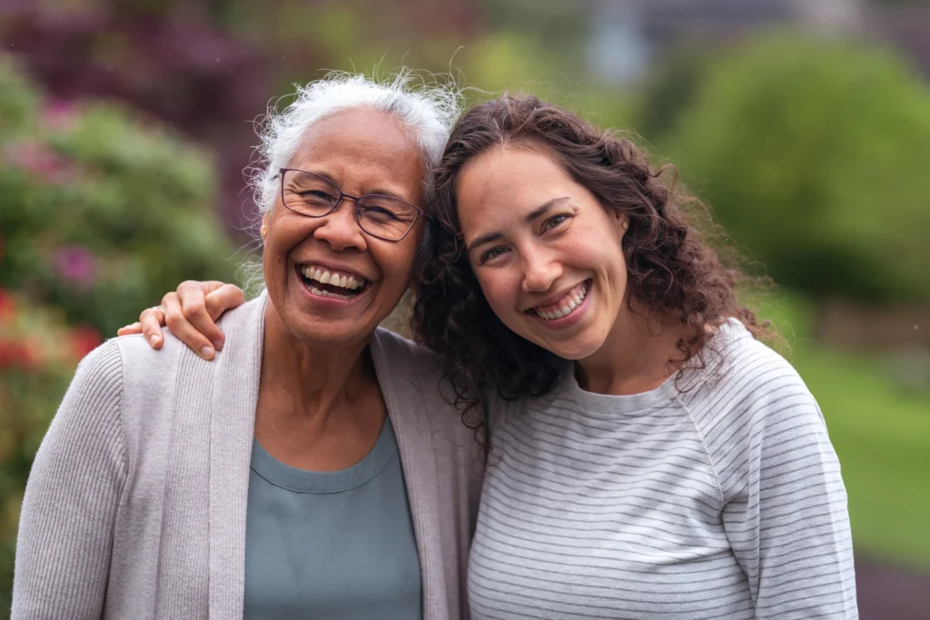 A senior woman smiling with her adult daughter at Monarch Landing, a memory care community in Naperville, IL.