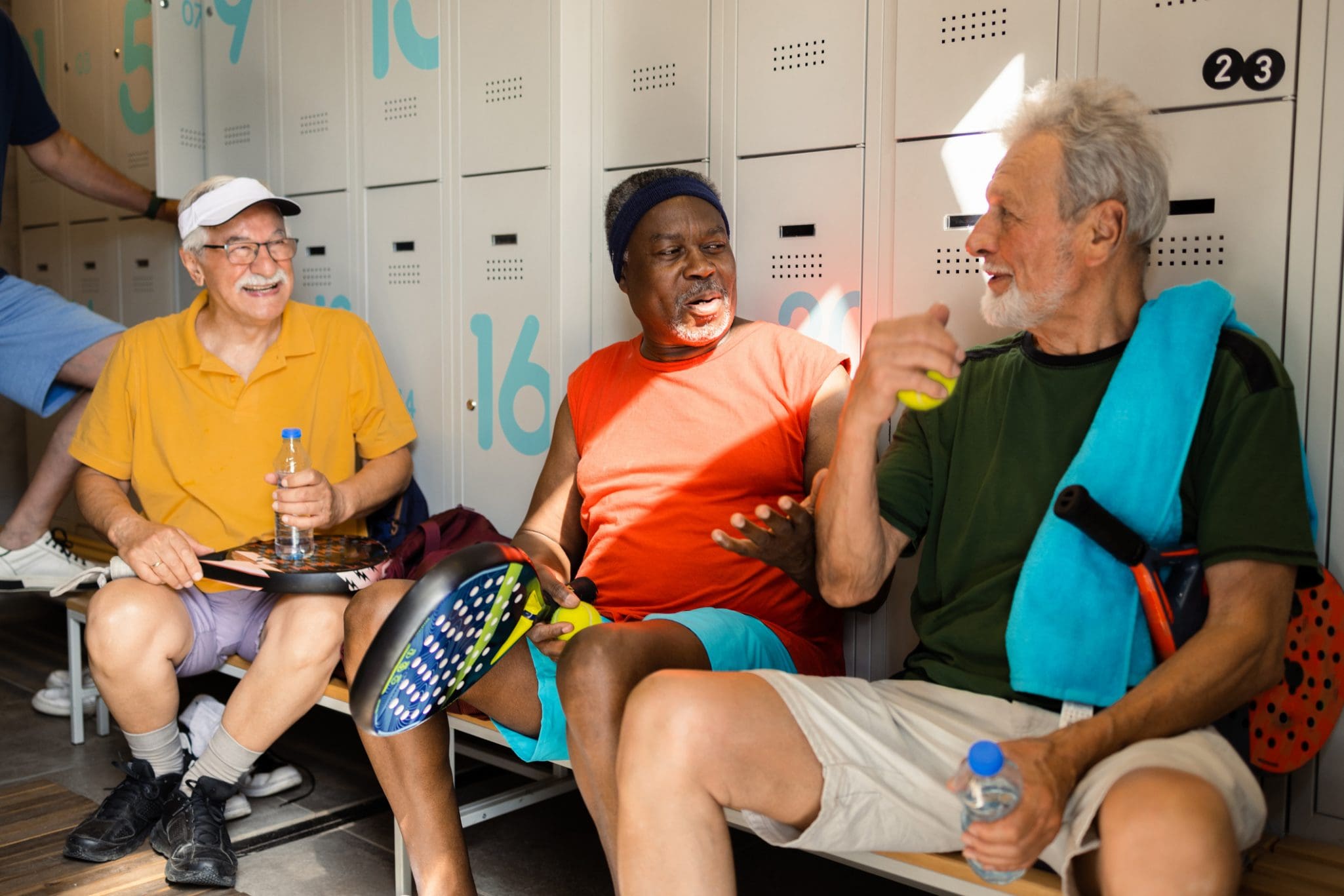 Three senior men enjoying at the dress room after playing pickleball