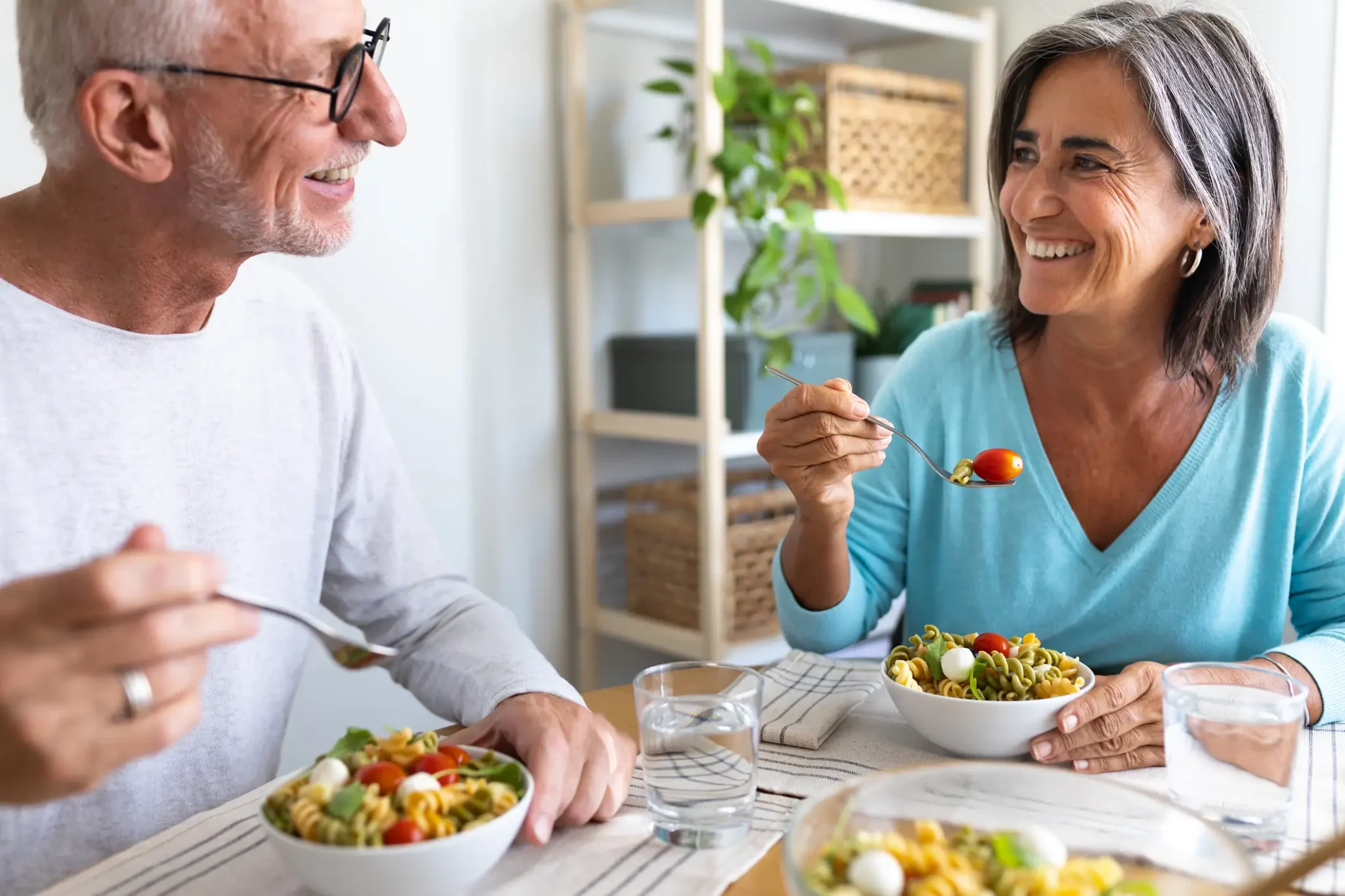 Senior couple enjoying a healthy pasta salad