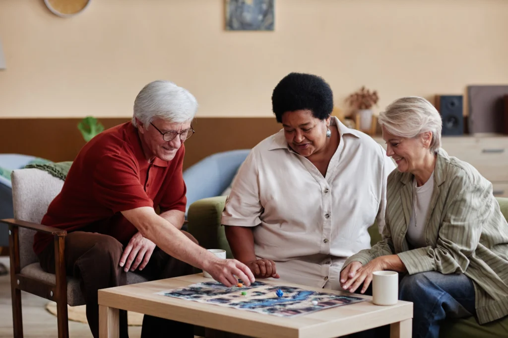 An older adult couple with a caregiver from Monarch Landing working on activities for seniors with dementia in Naperville, IL.