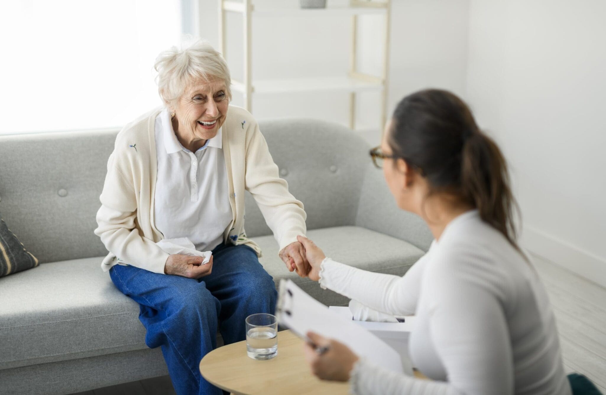 A old woman thinking with psychologist discussing memory care vs. assisted living. A old woman thinking with psychologist discussing memory care vs. assisted living.