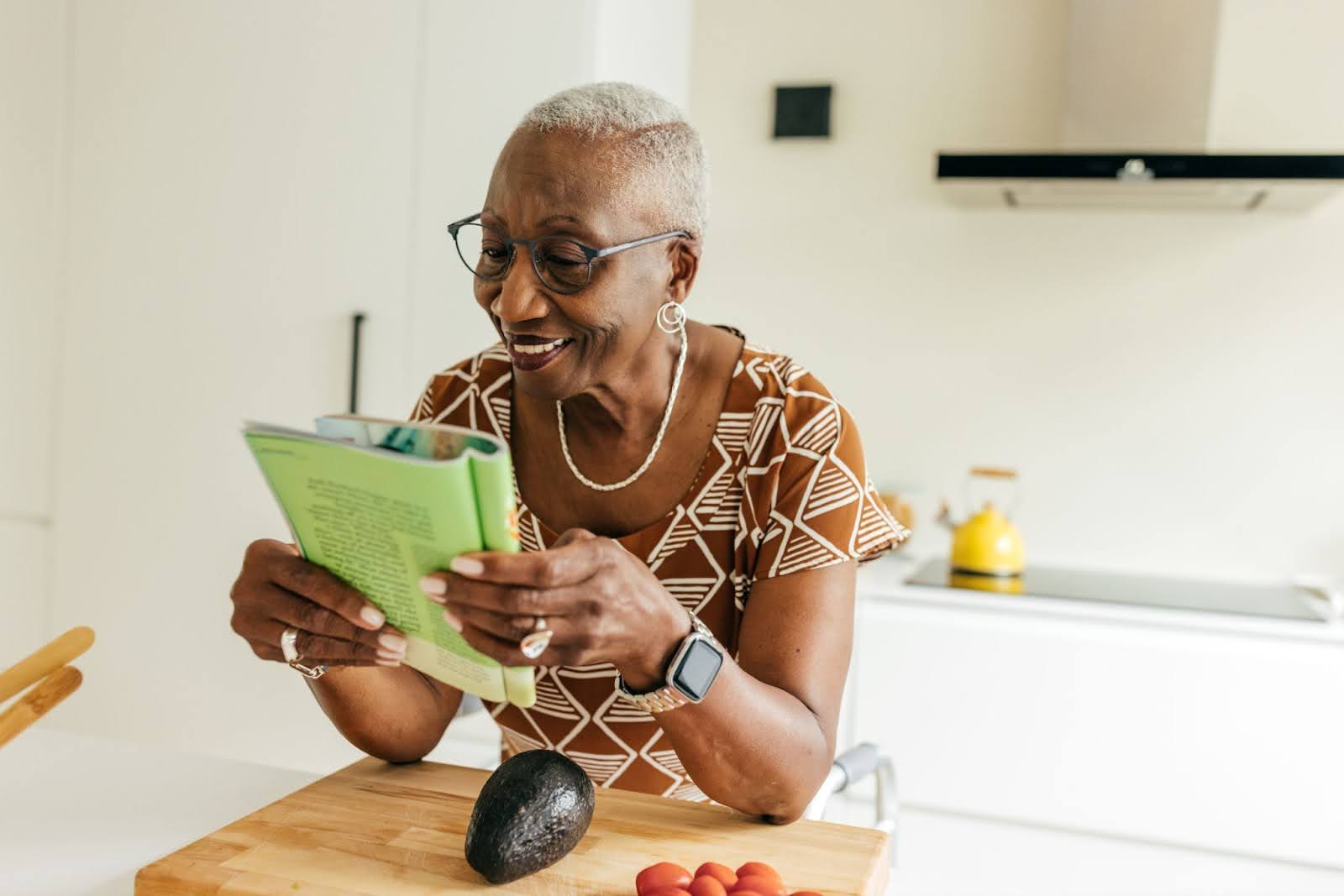 Senior woman reading a magazine smiling Senior woman reading a magazine smiling